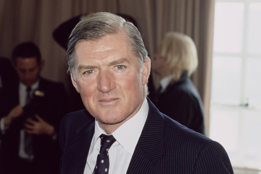 Cecil Parkinson wears a suit and tie.