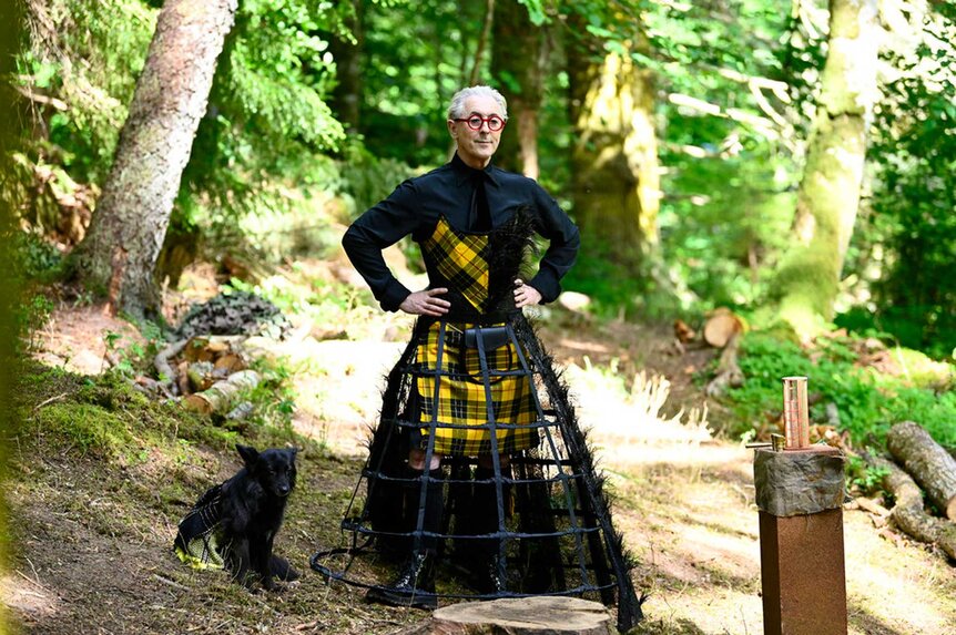 Alan Cumming wearing a plaid dress with a cage skirt on The Traitors Season 3, Episode 2.