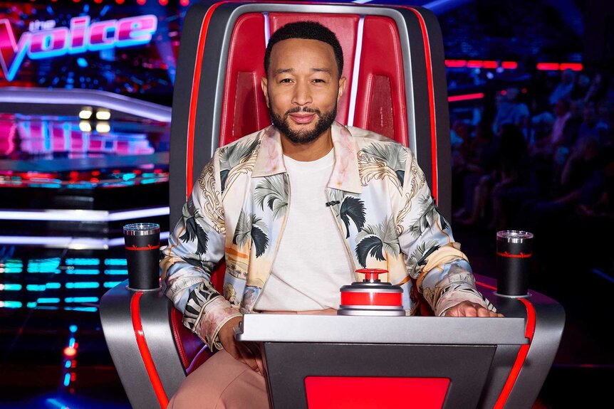 John Legend posing in the coaches chair on The Voice Season 27, Episode 1.