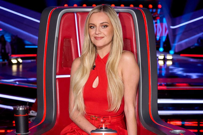 Kelsea Ballerini smiling and posing in her coach chair on The Voice Season 27, Episode 1.