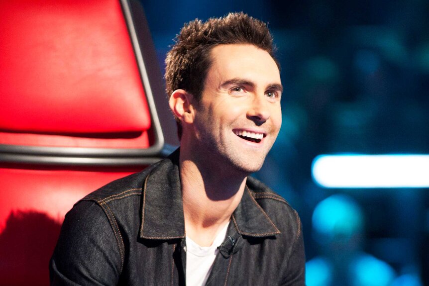 Adam Levine smiles in his coaches chair on The Voice Season 1, Episode 2.