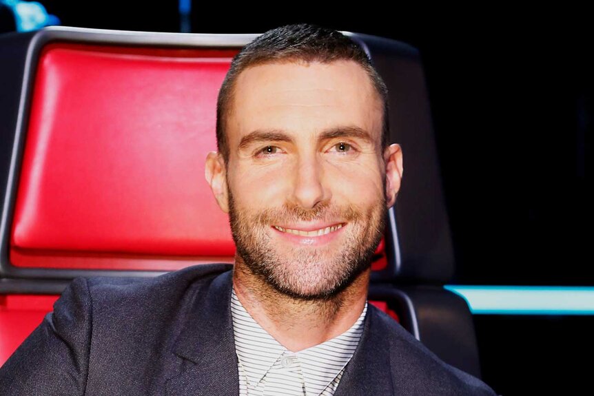 Adam Levine smiles in his coaches chair on The Voice Season 8, Episode 17A.