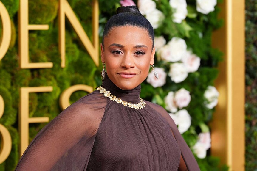 Ariana Debose posing and smiling at the 82nd Annual Golden Globes.