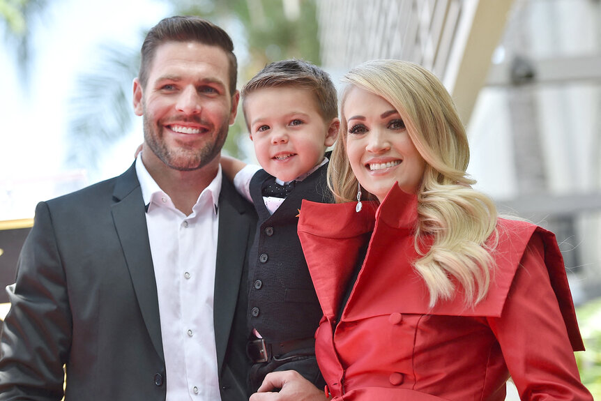 Carrie Underwood, Mike Fisher and their son Isaiah Michael smile together