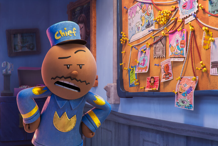 Chief stands next to a bulletin board in Dog Man