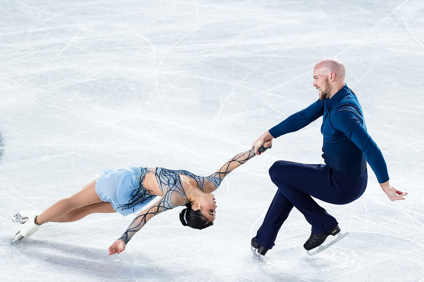 Ellie Kam and Danny O'Shea performing a figure skating routine together.