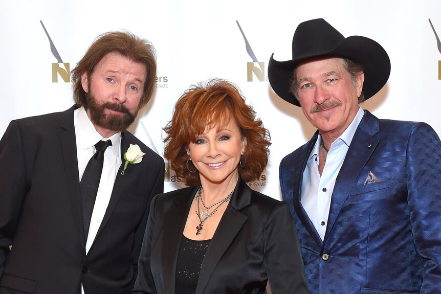 Ronnie Dunn, Reba McEntire and Kix Brooks pose together.