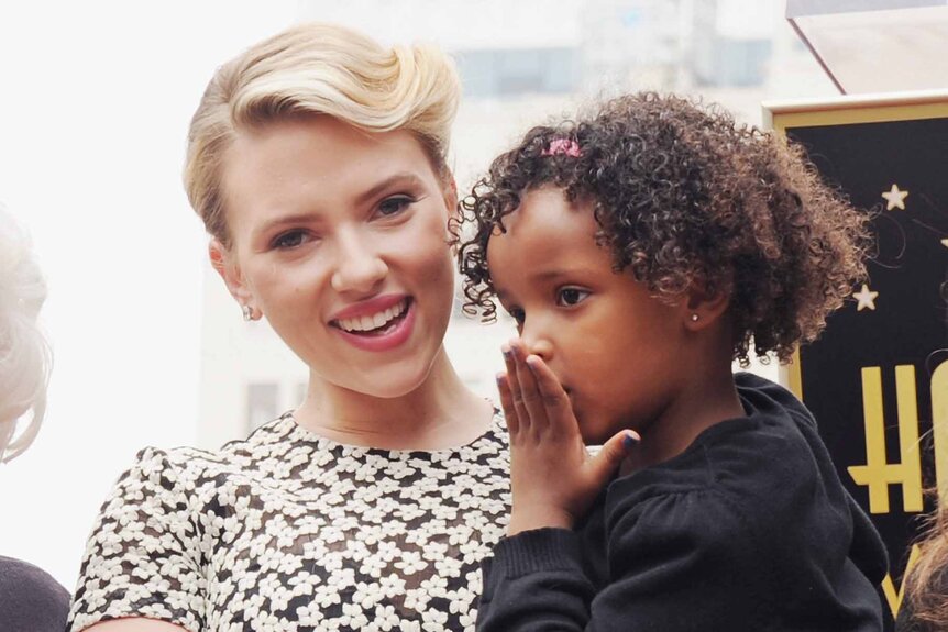 Scarlett Johansson smiles while holding her sister Fenan Sloan.