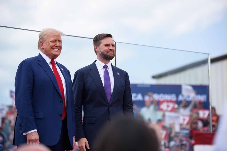 Donald Trump and J.D. Vance smile together.