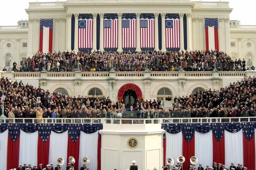 Thousands of people watch on as George W. Bush is inaugurated.