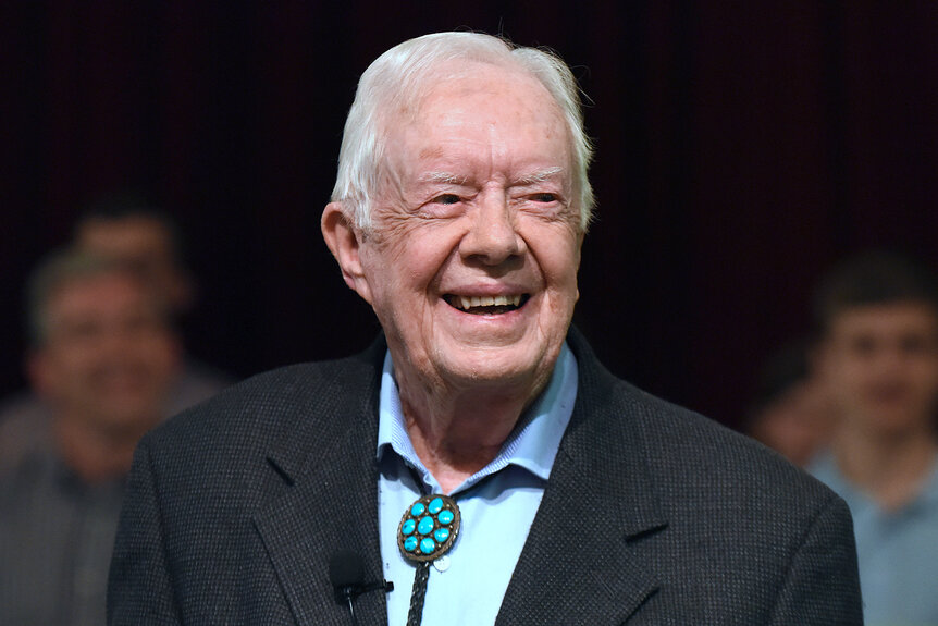 Jimmy Carter smiles on stage while speaking to the congregation at Maranatha Baptist Church