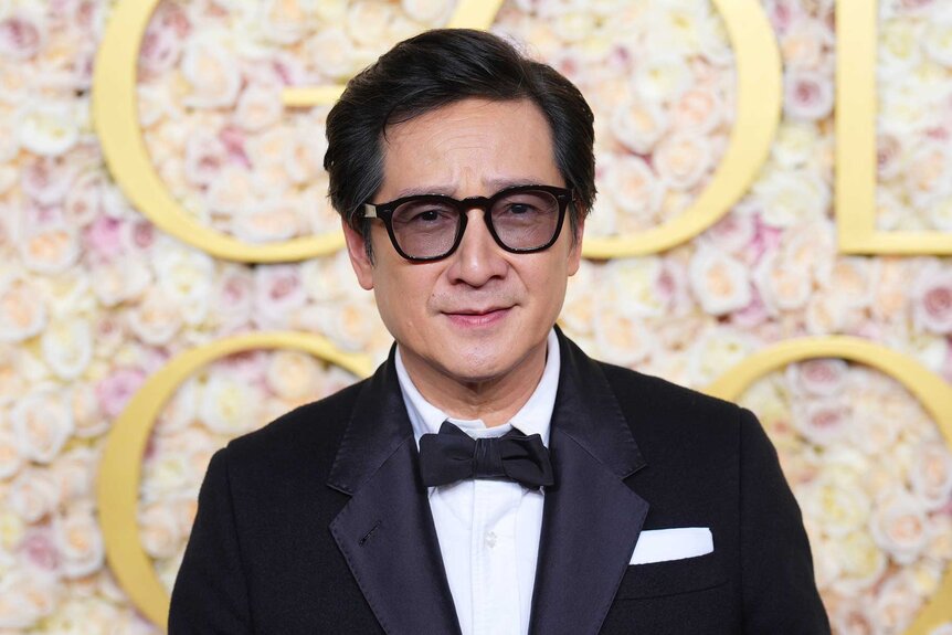 Ke Huy Quan posing at the 82nd Annual Golden Globes.