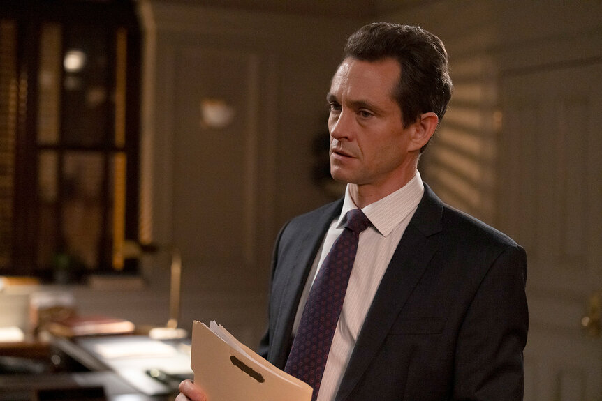 A.D.A. Nolan Price holds a folder in an office on Law And Order Season 24 Episode 11