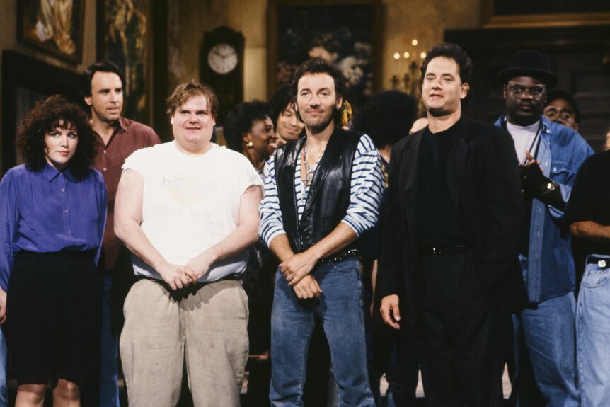 Kevin Nealon, Chris Farley, Bruce Springsteen, and Tom Hanks stand together onstage on SNL Episode 3519.