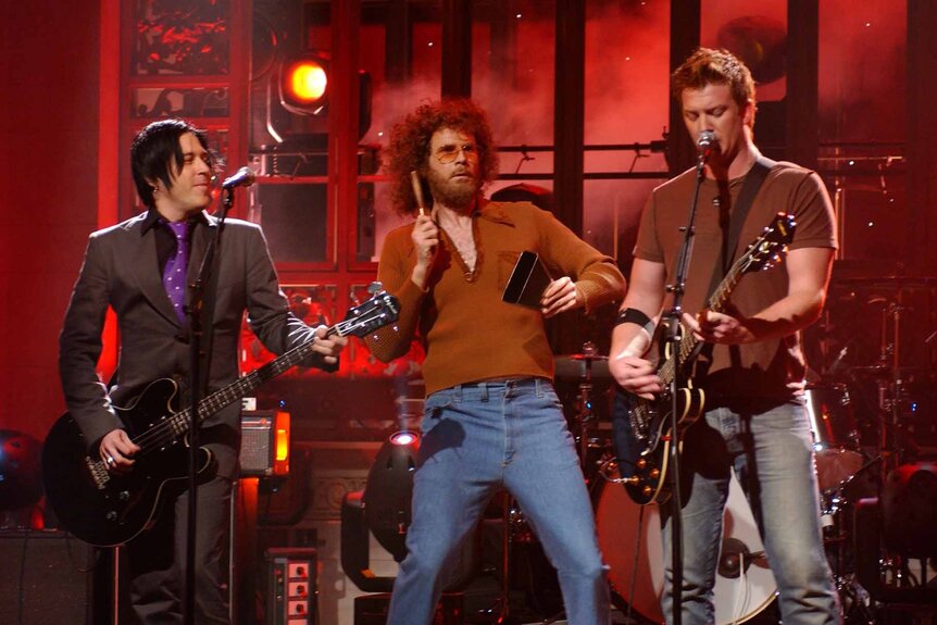 Gene Frenkle (Will Ferrell) performs onstage with Queens of the Stone Age on Saturday Night Live Episode 3019.