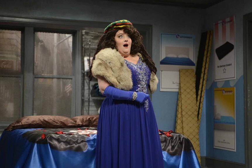 Janeen (Aidy Bryant) wears a blue gown on SNL Episode 1671.