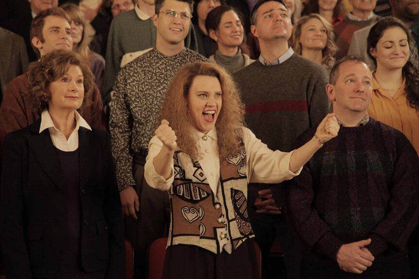 Kate McKinnon wears a sweater vest in an audience on SNL Episode 1679.