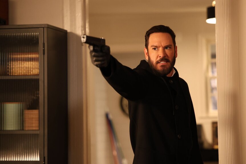 Sir (Mark-Paul Gosselaar) points a gun angrily on Found Episode 210.