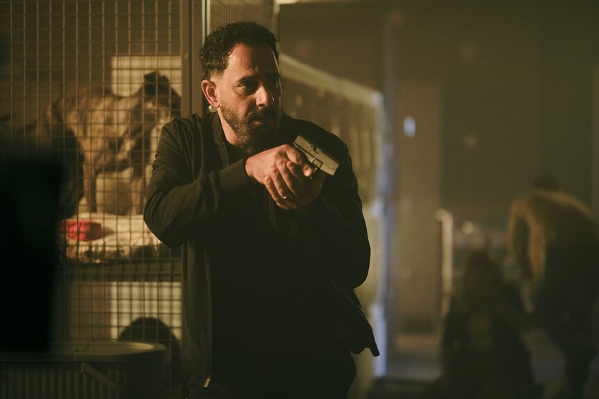 Ryan Hassani (Patrick Sabongui) wields a gun on The Hunting Party Episode 101.