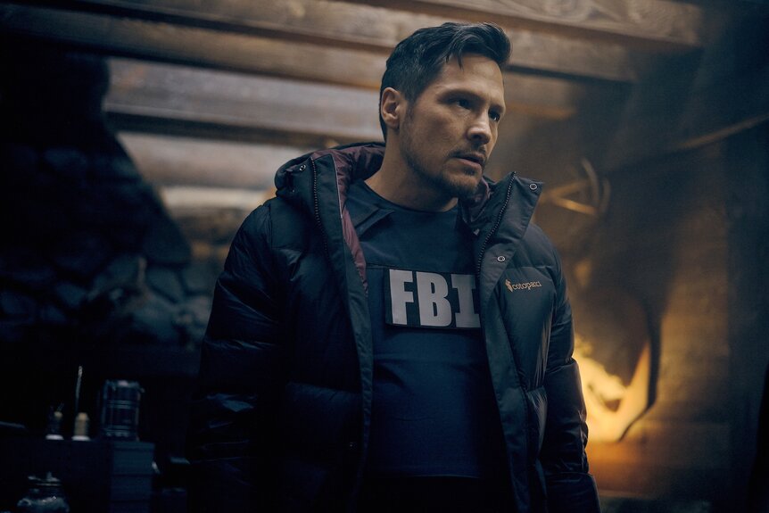 Oliver Odell (Nick Wechsler) wears an FBI vest on The Hunting Party Episode 101.