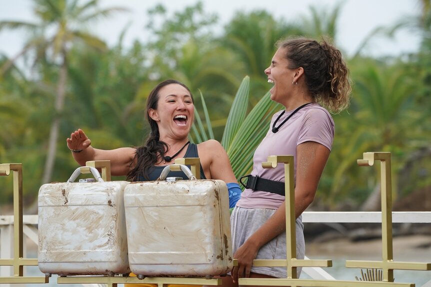 Courtney "CK" Kim and Maria-Grace Cook celebrate with their briefcases on Deal or No Deal Island Episode 203.