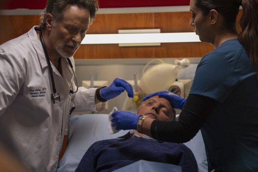 Dr. Dean Archer (Steven Weber) and Nurse Doris (Lorena Diaz) tend to an injured man's eye in Chicago Fire Episode 1311.