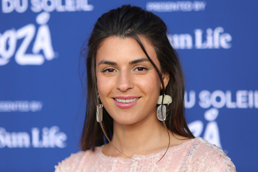 Sara Garcia smiles in a light pink dress on the red carpet