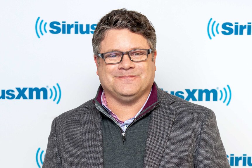 Sean Astin smiling and posing the SiriusXM Studios.