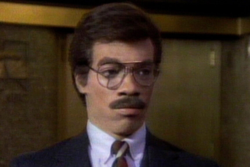 Eddie Murphy wears a mustache and glasses during a sketch on Saturday Night Live Season 10