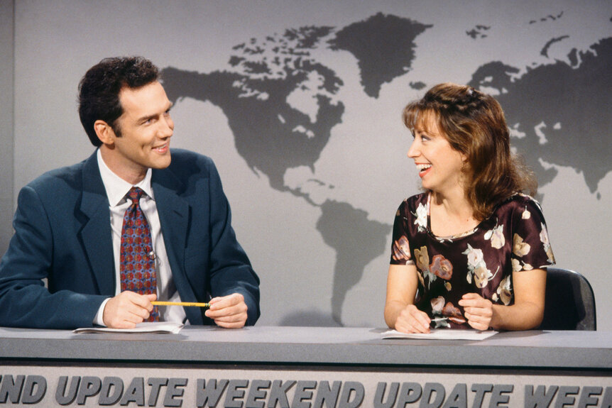 Norm Macdonald and Cheri Oteri sit at a desk together on Saturday Night Live Season 21