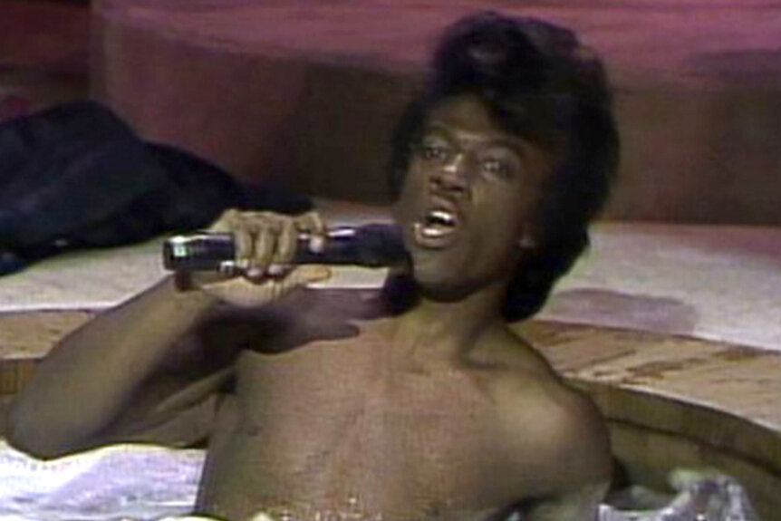 Eddie Murphy sits in a hot tub as James Brown on Saturday Night Live Season 9.