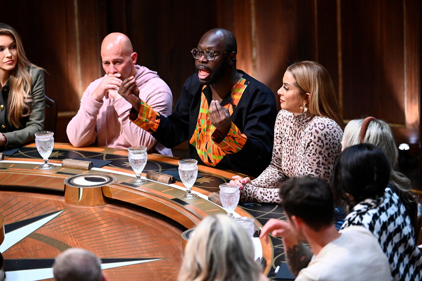 Tony Vlachos Bob The Drag Queen and Robyn Dixon sit at the round table on The Traitors Season 3 Episode 3