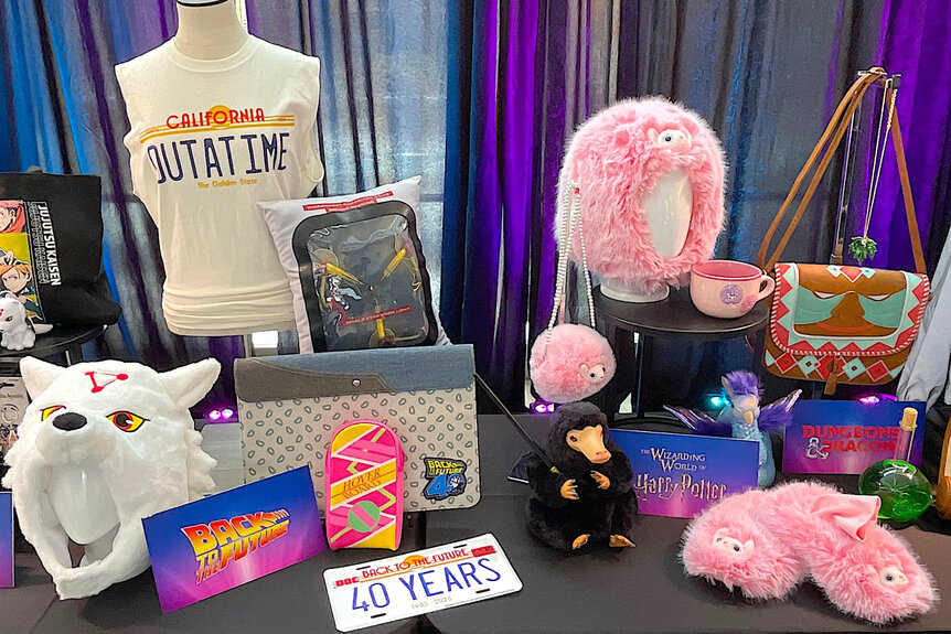 A wolf hat, a t-shirt and other merch on a table at Universal Fanfest Nights