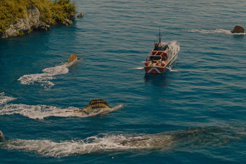 The Mosasaurus and Spinosauruses circle a boat in Jurassic World Rebirth (2025).