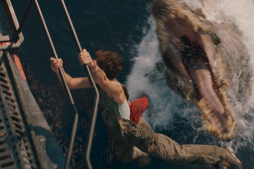 Philippine Velge hangs off a boat while a Spinosaurus leaps out of the water with an open mouth in Jurassic World Rebirth (2025).