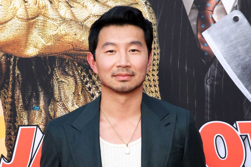 Simu Liu posing at the premiere of Jackpot.