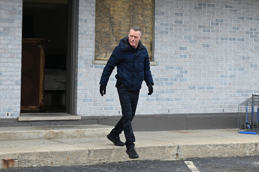 Sgt. Hank Voight walks outside of a building on Chicago P.D Season 12 Episode 14