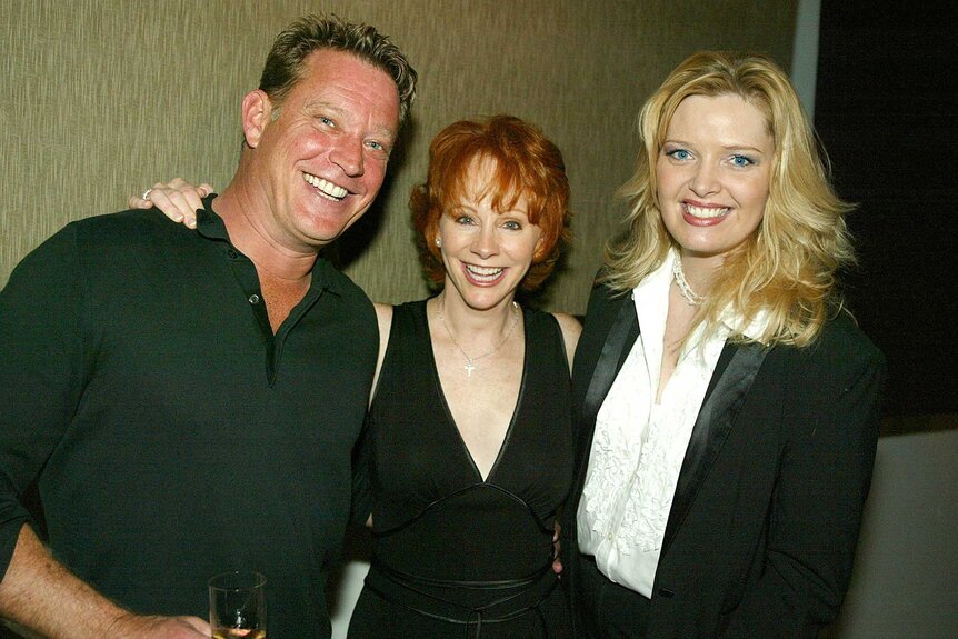 Chris Rich, Reba McEntire, and Melissa Peterman posing at The 2003 Winter TCA Tour Party.