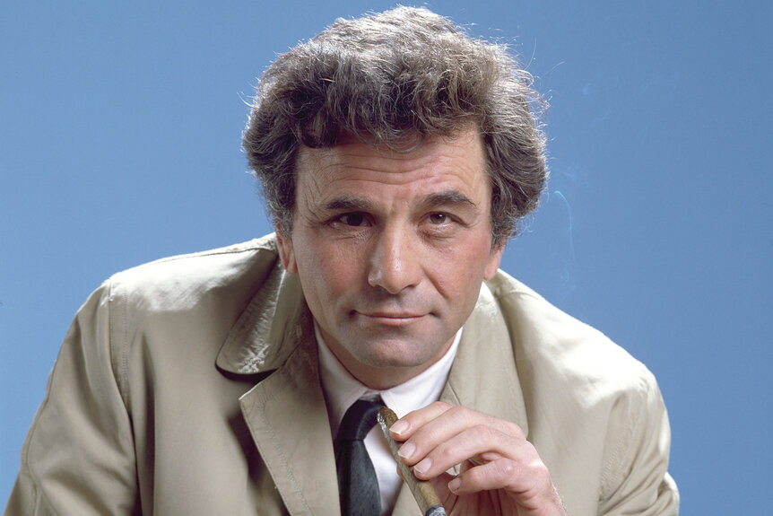 Columbo holds a cigar and wears a tan jacket