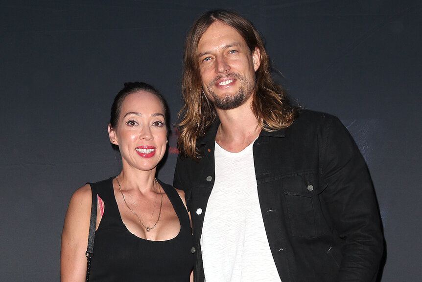 David Genat and his wife Pearl pose together on the red carpet at a movie premiere