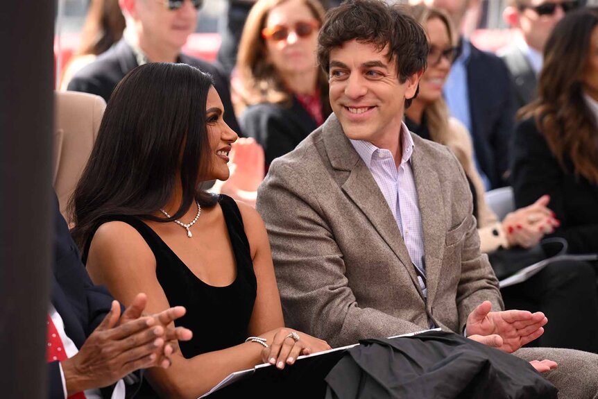 Mindy Kaling and B.J. Novak smile next to each other at Mindy's Hollywood Walk Of Fame star ceremony.