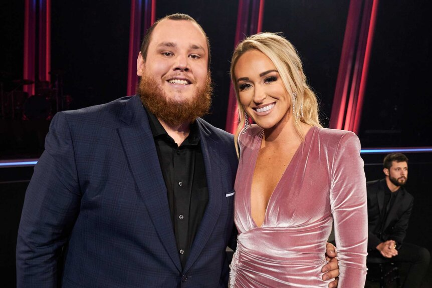 Luke Combs and wife Nicole Hocking smiling at the 54th Annual CMA Awards.