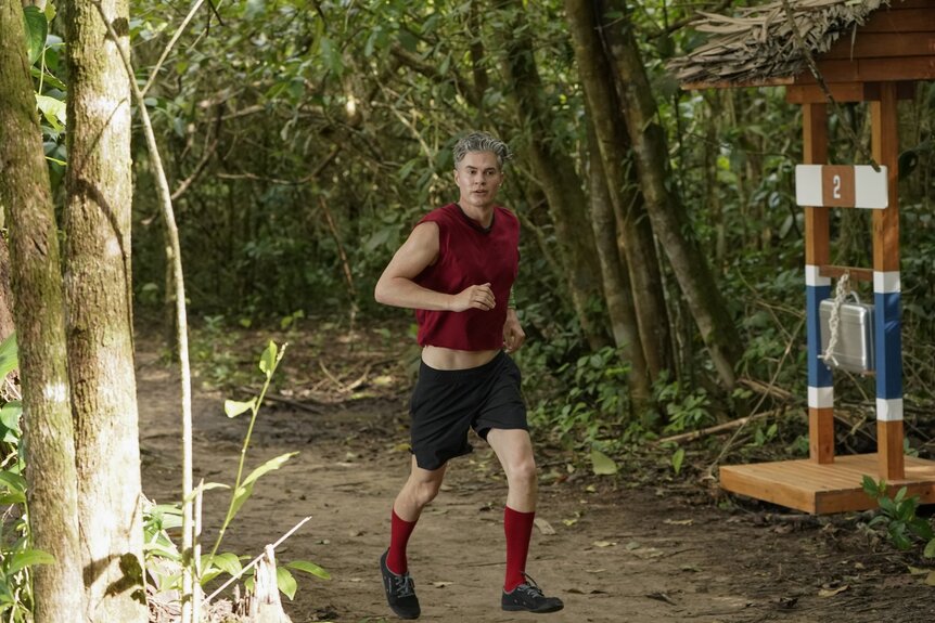 “Dr. Will” Kirby runs through the woods in Deal or No Deal Island Episode 207.