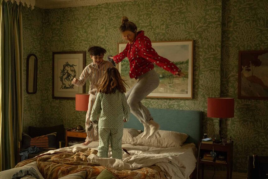 Bridget Jones (Renée Zellweger) jumps on a bed with two kids in Bridget Jones: Mad About the Boy (2025).