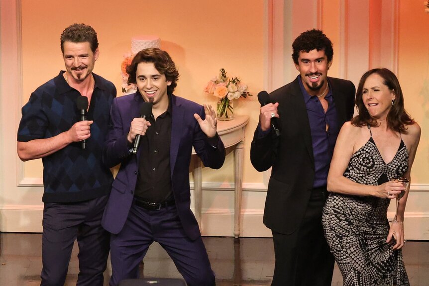 Pedro Pascal, Marcello Hernandez, Bad Bunny, and Molly Shannon dancing while holding microphones.Pedro Pascal, Marcello Hernandez, Bad Bunny, and Molly Shannon dancing while holding microphones.