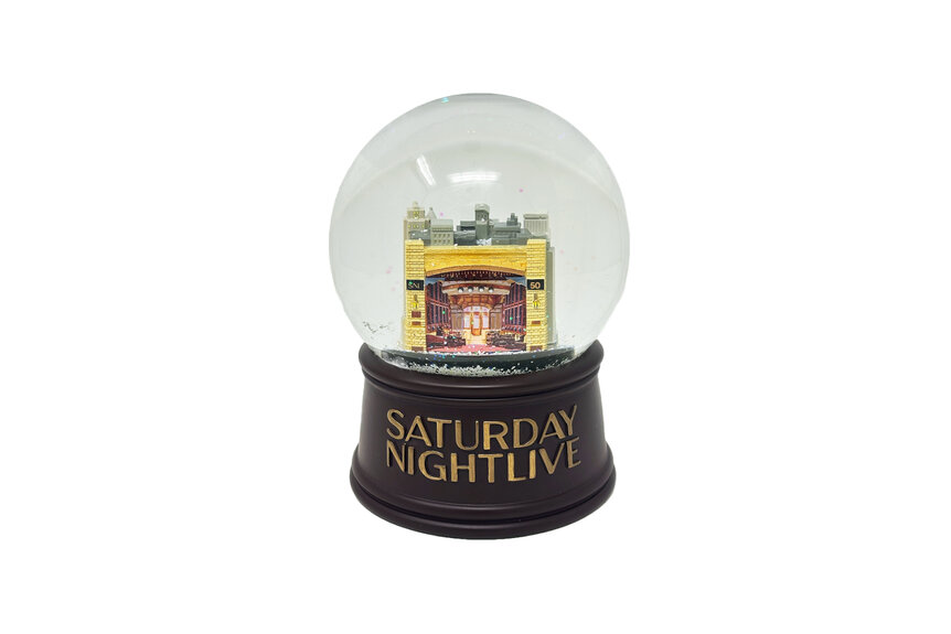 A snow globe with a replica of The Stage for Saturday Night Live 50th season