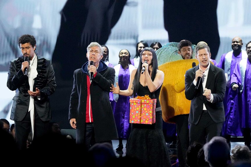 Bad Bunny, Chris Parnell, Lady Gaga, and Andy Samberg performing on stage during SNL50: The Homecoming Concert.