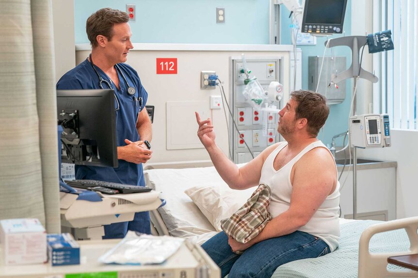 Dr. Bruce and Danny talking in a hospital room on St. Denis Medical Season 1, Episode 10.