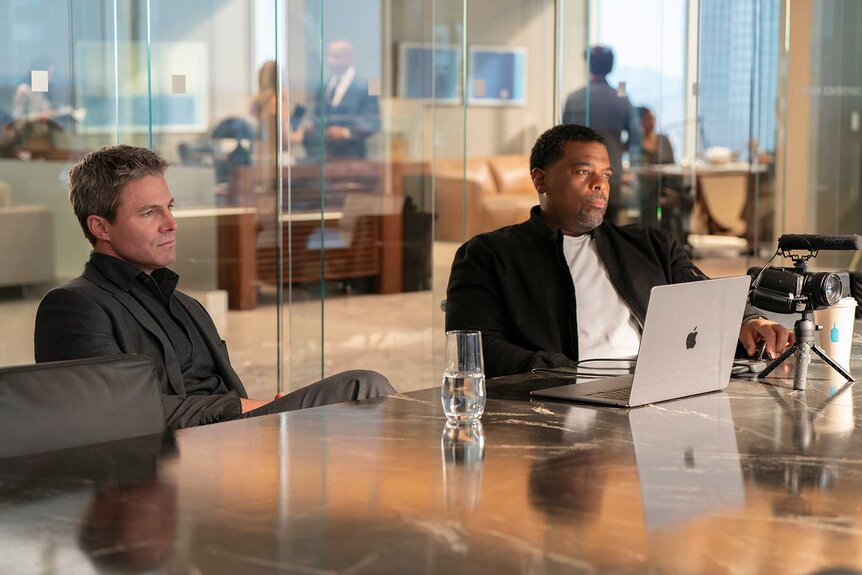 Ted Black and Kevin Dillion sitting at a desk in Suits LA Season 1, Episode 2.