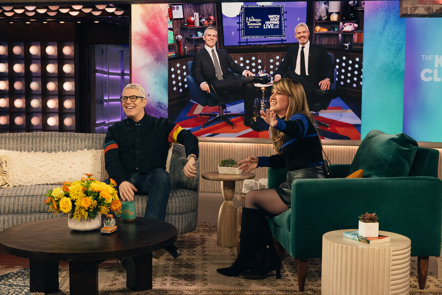 Andy Cohen and Kelly Clarkson look at a photo on a screen on The Kelly Clarkson Show Season 6, Episode 96.